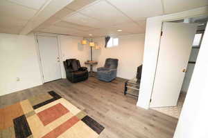 Sitting room featuring baseboards, recessed lighting, wood finished floors, and a paneled ceiling