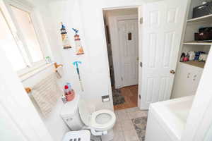 Bathroom featuring tile patterned floors and toilet