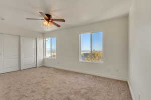 Unfurnished bedroom with baseboards, a closet, visible vents, and carpet