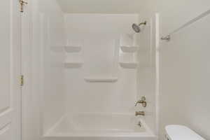 Bathroom with shower / bathtub combination and toilet
