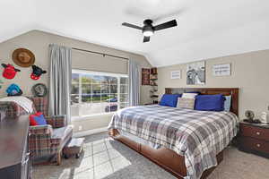 Bedroom featuring vaulted ceiling, baseboards, carpet, and ceiling fan