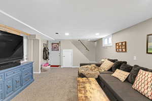 Carpeted living room featuring baseboards and recessed lighting