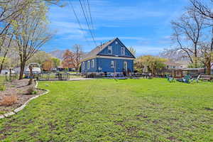 View of yard with a mountain view and fence