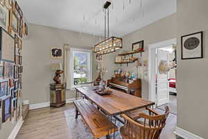 Dining room with light wood-type flooring and baseboards