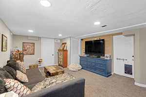 Living area with recessed lighting, carpet flooring, and baseboards