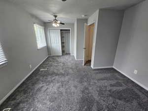 Unfurnished bedroom with a closet, carpet flooring, baseboards, and visible vents