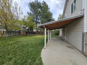 View of yard with a fenced backyard and a patio
