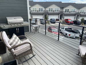 Wooden terrace with an attached garage and driveway