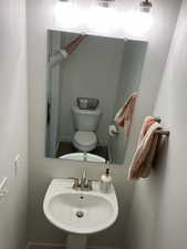 Half bathroom with toilet and a sink