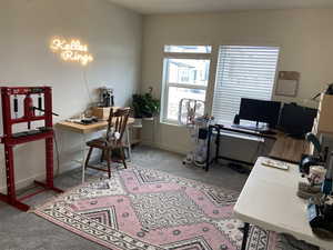 Carpeted office space featuring baseboards
