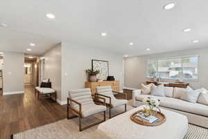 Living area featuring baseboards, recessed lighting, and dark wood-style floors