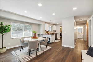 Dining room featuring baseboards, recessed lighting, and dark wood-style floors