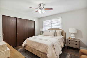 Bedroom with a ceiling fan, wood finished floors, and a closet