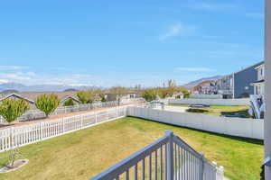 View of yard featuring a fenced backyard, a mountain view, and a residential view