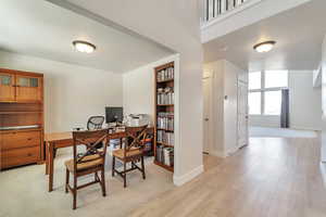 Office space featuring light wood-type flooring and baseboards