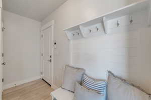 Mudroom with baseboards and light wood-style floors