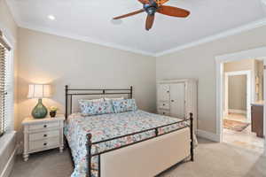 Bedroom featuring baseboards, recessed lighting, light colored carpet, ceiling fan, and crown molding