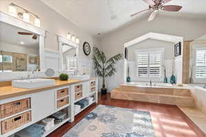 Full bathroom with vaulted ceiling, an enclosed shower, a garden tub, and ceiling fan
