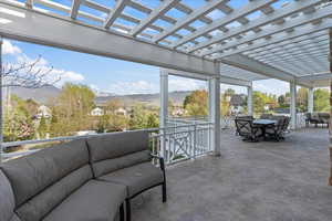 View of patio featuring a pergola, outdoor lounge area, outdoor dining space, and a mountain view