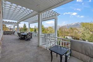 View of patio with a pergola, an outdoor hangout area, and a mountain view