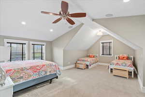 Carpeted bedroom featuring recessed lighting, lofted ceiling, a ceiling fan, and baseboards
