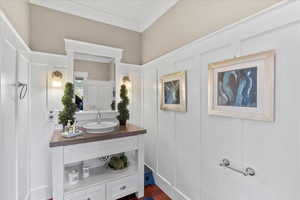 Interior space featuring a sink and a decorative wall
