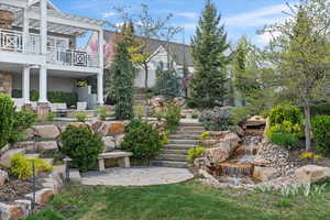 View of yard with stairway, a pergola, and a patio area