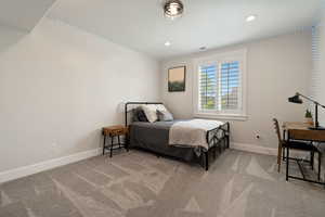 Carpeted bedroom with visible vents, baseboards, and recessed lighting