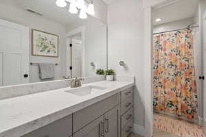 Bathroom featuring recessed lighting, visible vents, vanity, and a shower with curtain