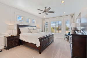 Bedroom with a ceiling fan, baseboards, recessed lighting, and light colored carpet