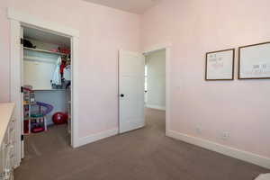 Unfurnished bedroom with baseboards, a closet, and carpet
