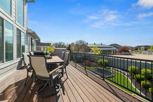 Deck featuring outdoor dining area, fence, and a residential view