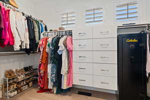 Walk in closet with visible vents and carpet