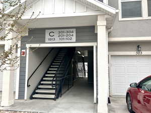 Doorway to property with stucco siding and board and batten siding