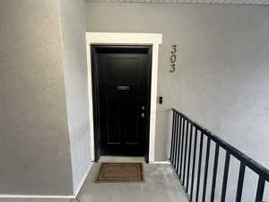 View of exterior entry featuring stucco siding