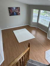 Interior space featuring baseboards, wood finished floors, and visible vents