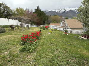 View of yard featuring a mountain view and fence