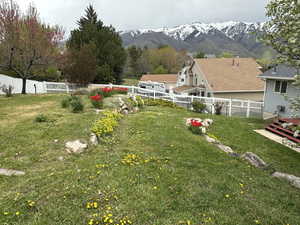 View of yard with a fenced backyard and a mountain view