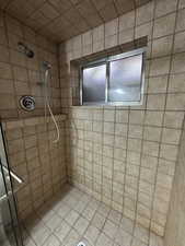 Full bathroom featuring a shower stall