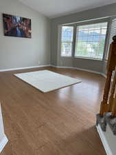 Unfurnished room featuring baseboards and wood finished floors