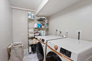 Laundry area featuring separate washer and dryer and laundry area