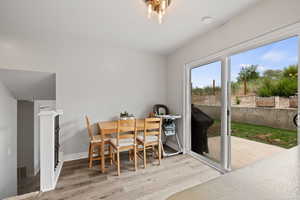 Dining space with wood finished floors, visible vents, and baseboards
