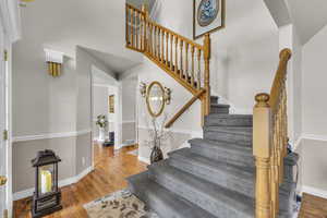 Bright vaulted entry w/ hardwood flooring.