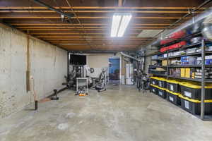 Basement featuring freestanding refrigerator, washer and dryer and plumbed for additional bathroom