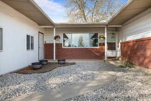 View of exterior entry with brick siding