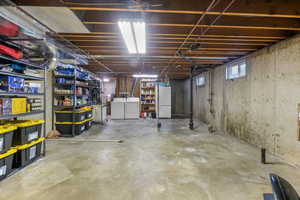 Basement featuring freestanding refrigerator, washer and dryer and plumbed for additional bathroom