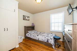 Bedroom with baseboards and wood finished floors