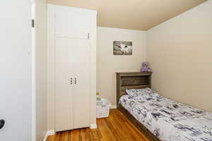 Bedroom featuring light wood-style flooring and baseboards