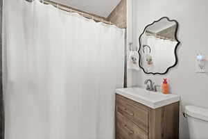 Full bathroom featuring vanity and toilet