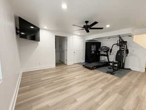 Exercise room featuring baseboards, wood finished floors, recessed lighting, and ceiling fan